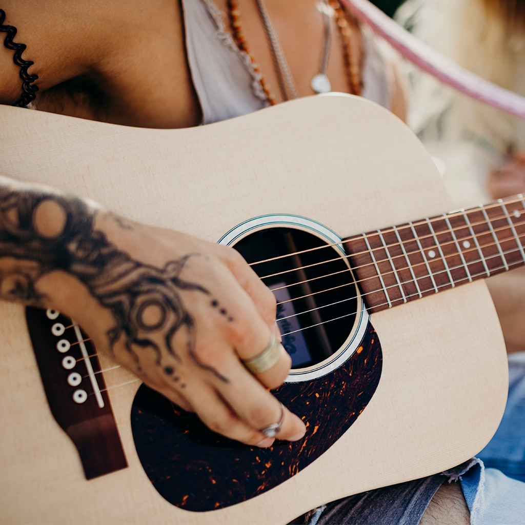 Strumming an acoustic guitar